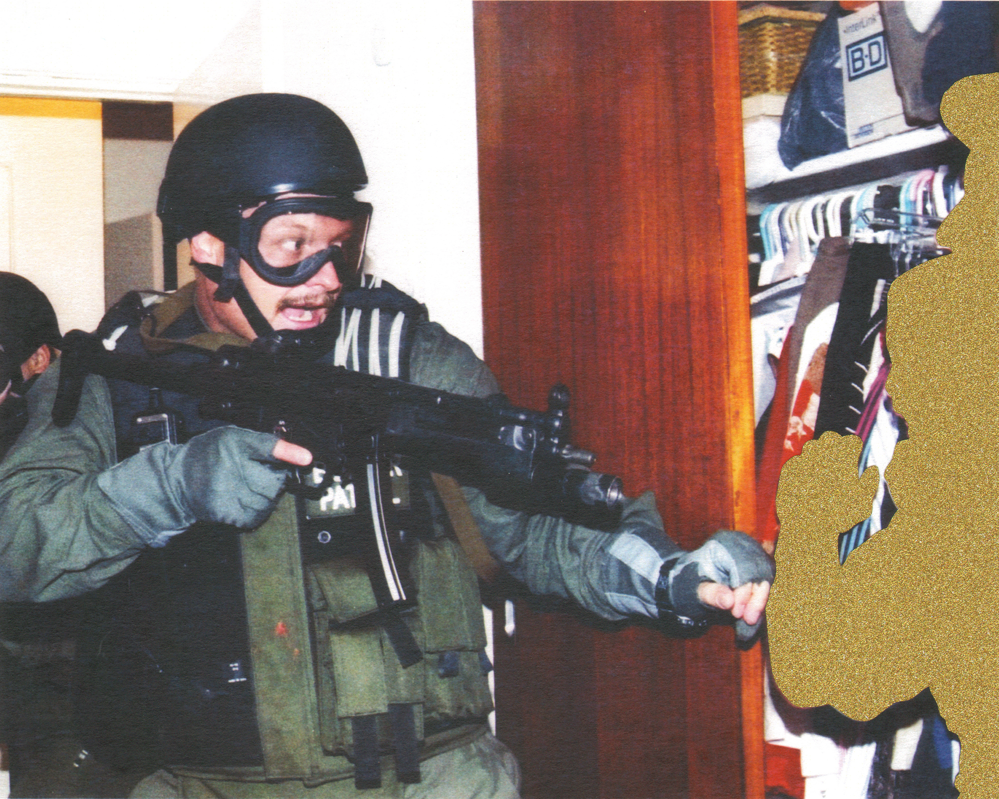 <em>Fisherman Donato Dalrymple holds 6-year-old Elian Gonzalez inside a bedroom closet Saturday as a Border Patrol agent puts his arm out to the boy moments after federal agents raided the Miami home. (Miami Herald / 2000)</em>